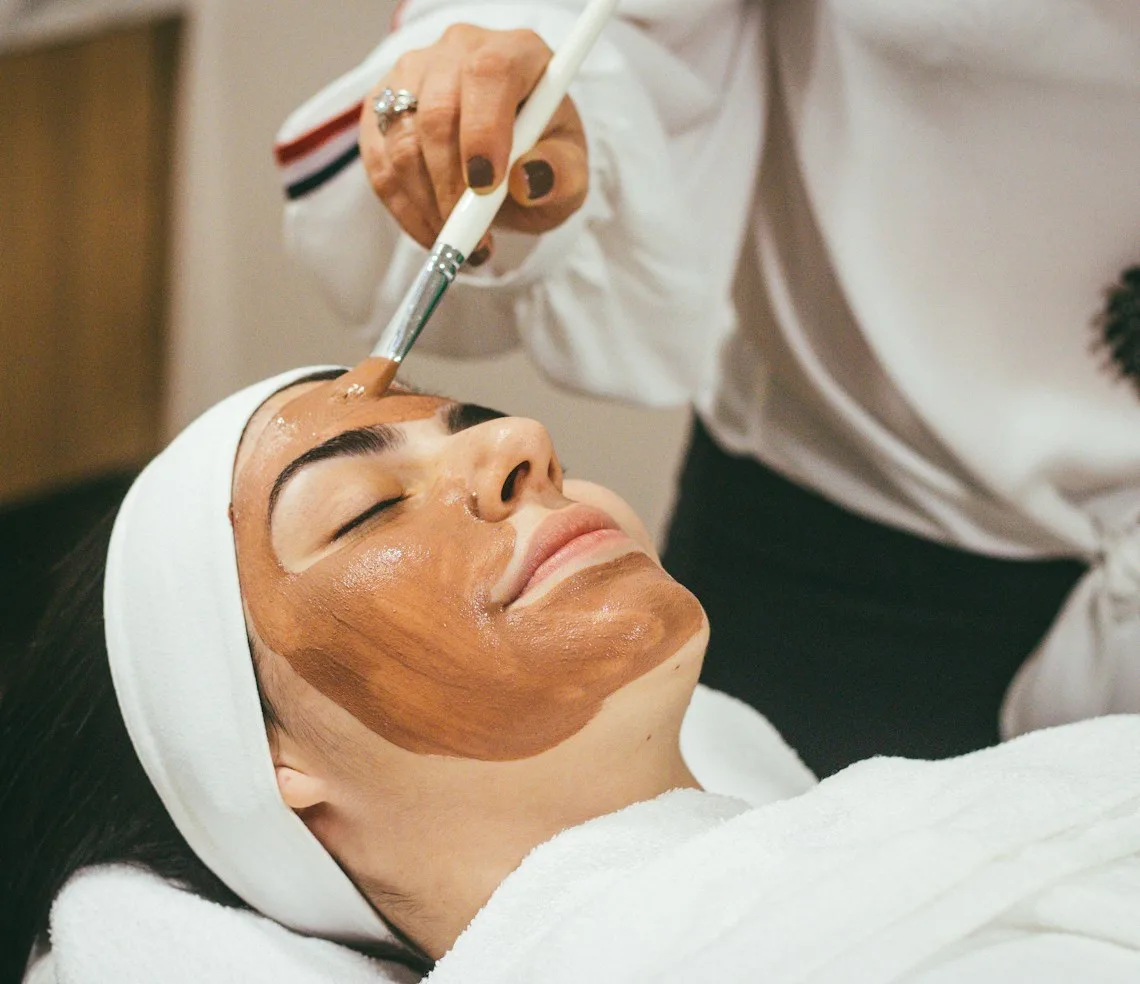 A cosmetologist carrying out a facial treatment in the treatment room