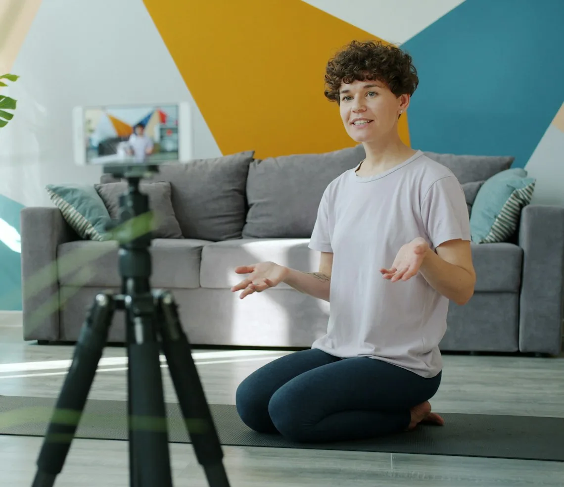 A course creator recording a lesson on a tripod-mounted camera