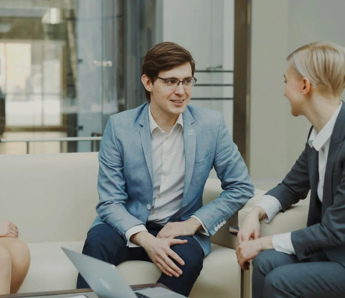 A mentor talking with a client in a bright office