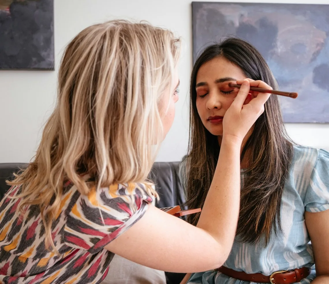 A brow artist tinting a client’s brows in the studio