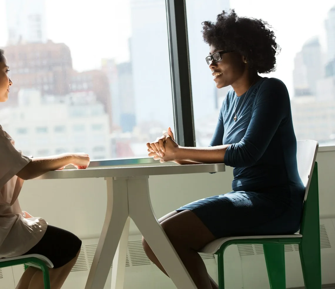 A recruiter interviewing a candidate in a meeting room