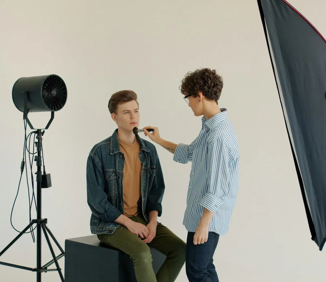 A photographer working with models under a studio light