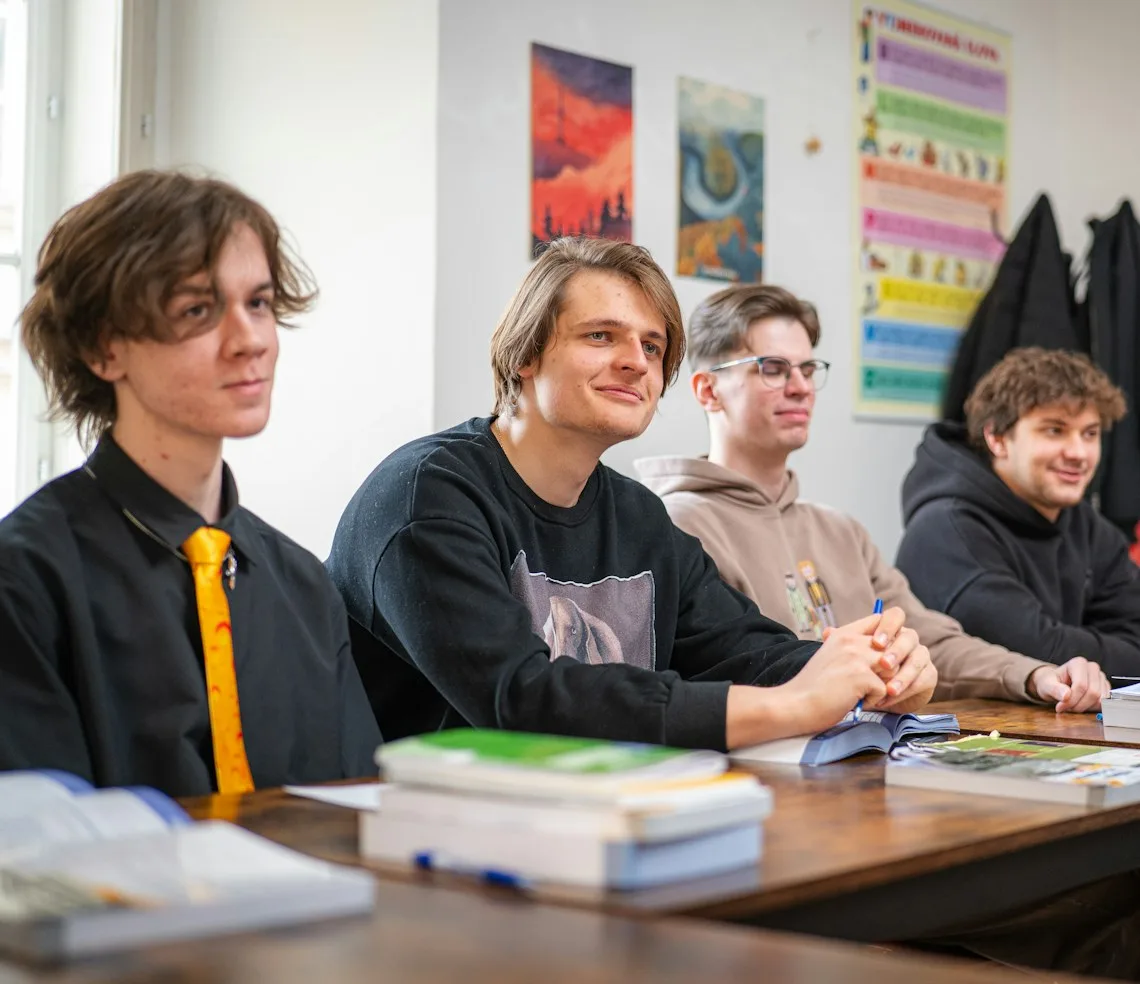 Teenagers preparing for an exam at their desks in a classroom
