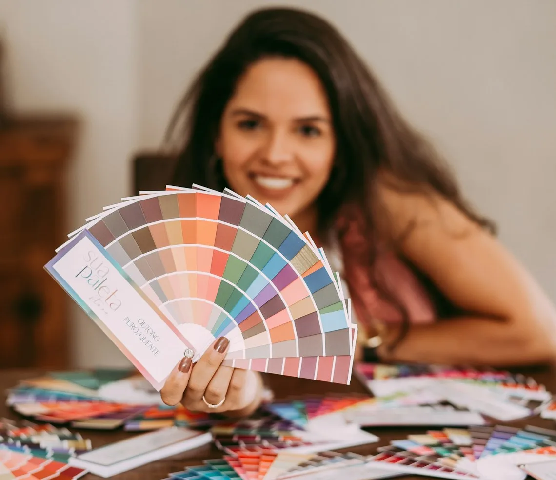 An interior designer choosing colours from a swatch fan