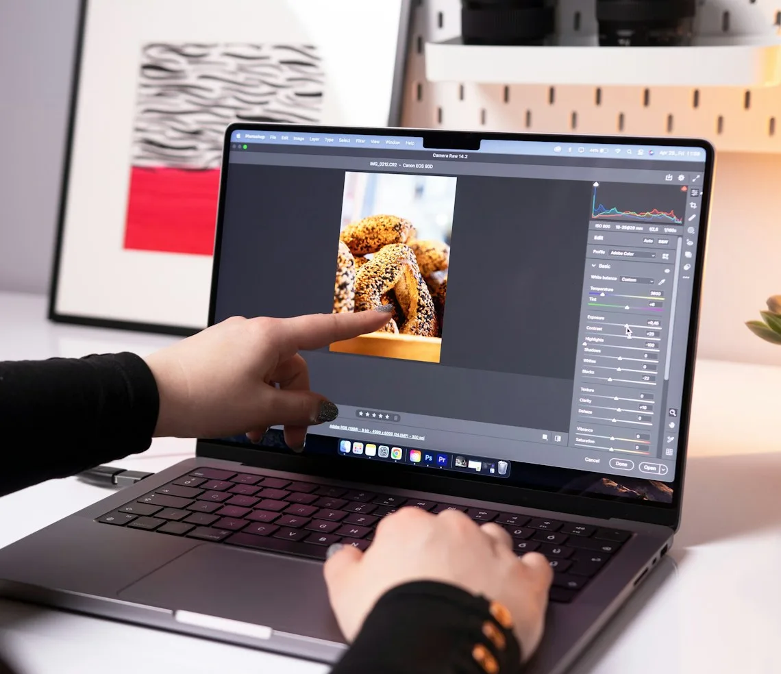 A creator editing a photo on a laptop