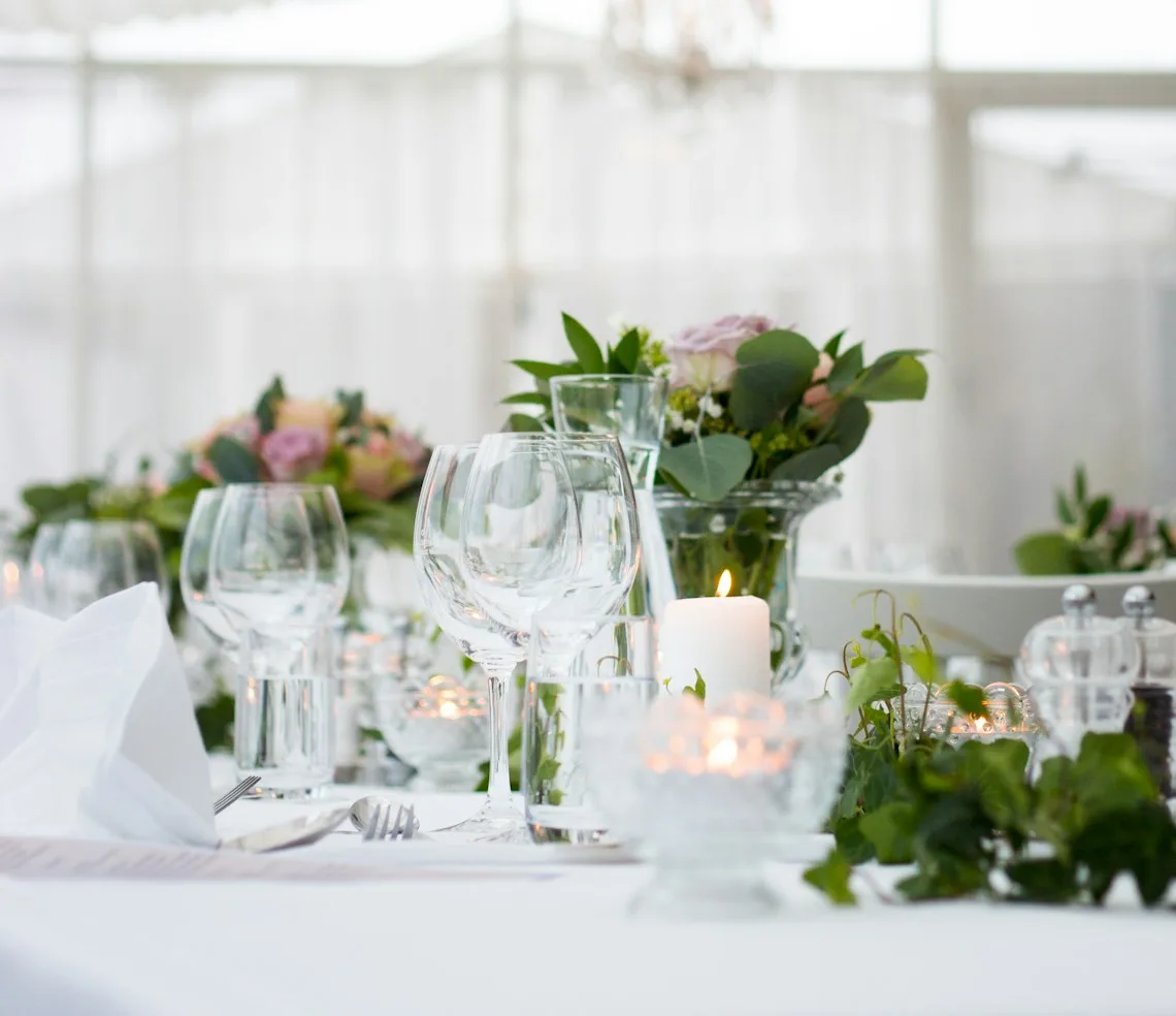 A laid table with flowers and candles before an event