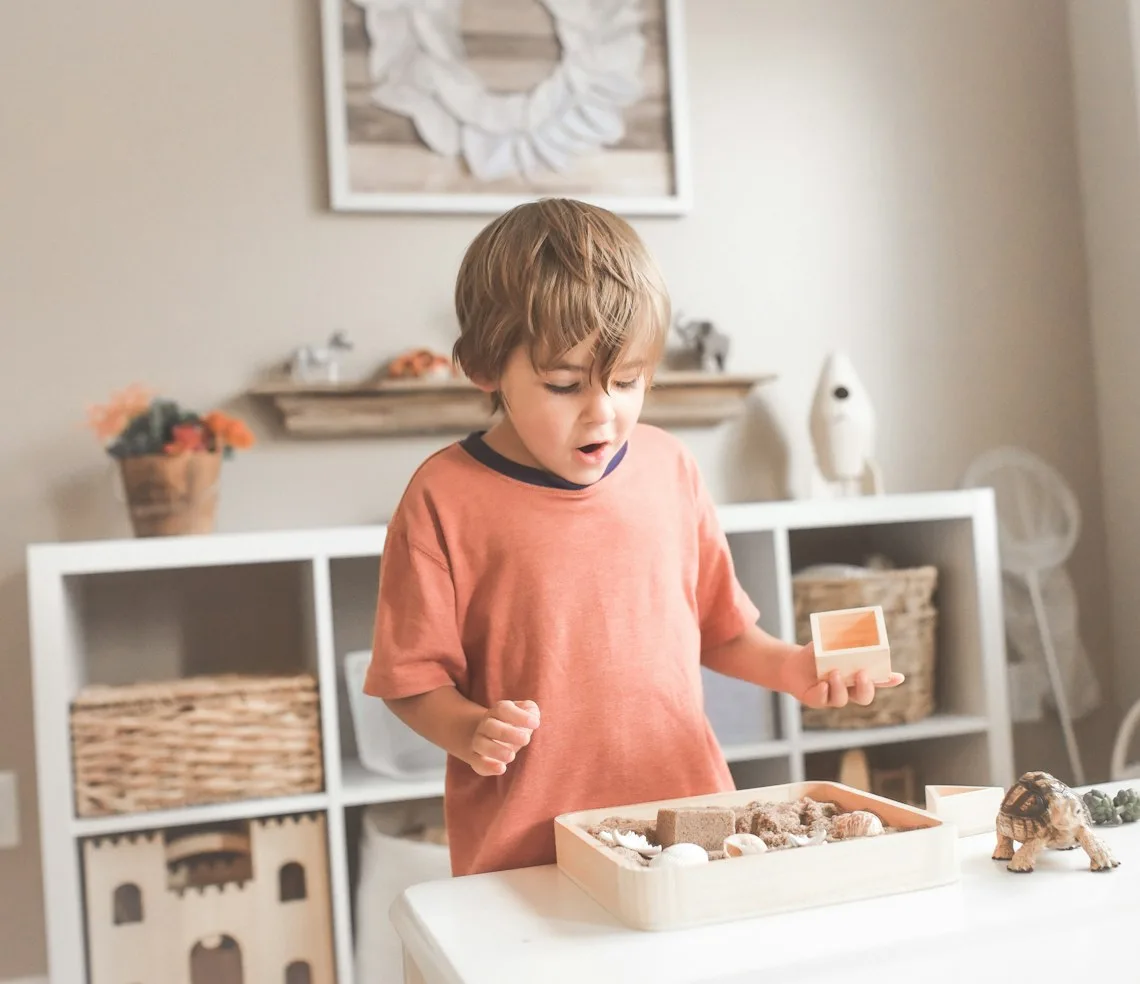 A child playing with wooden materials at a development centre