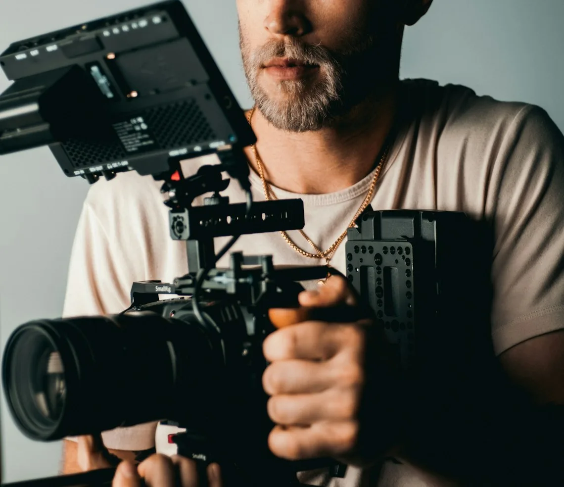 A videographer filming with a camera on a gimbal