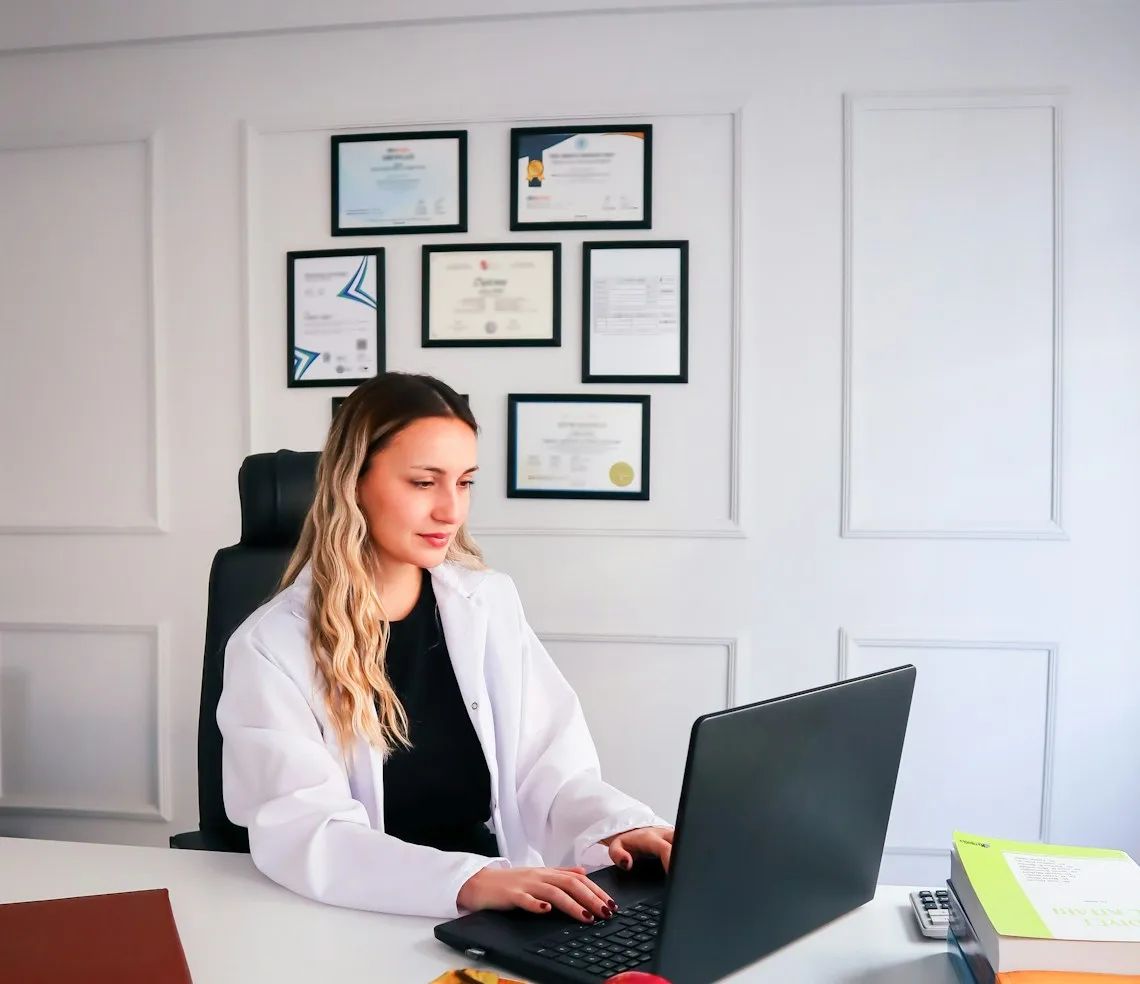 A dietitian working at a laptop in the consulting room