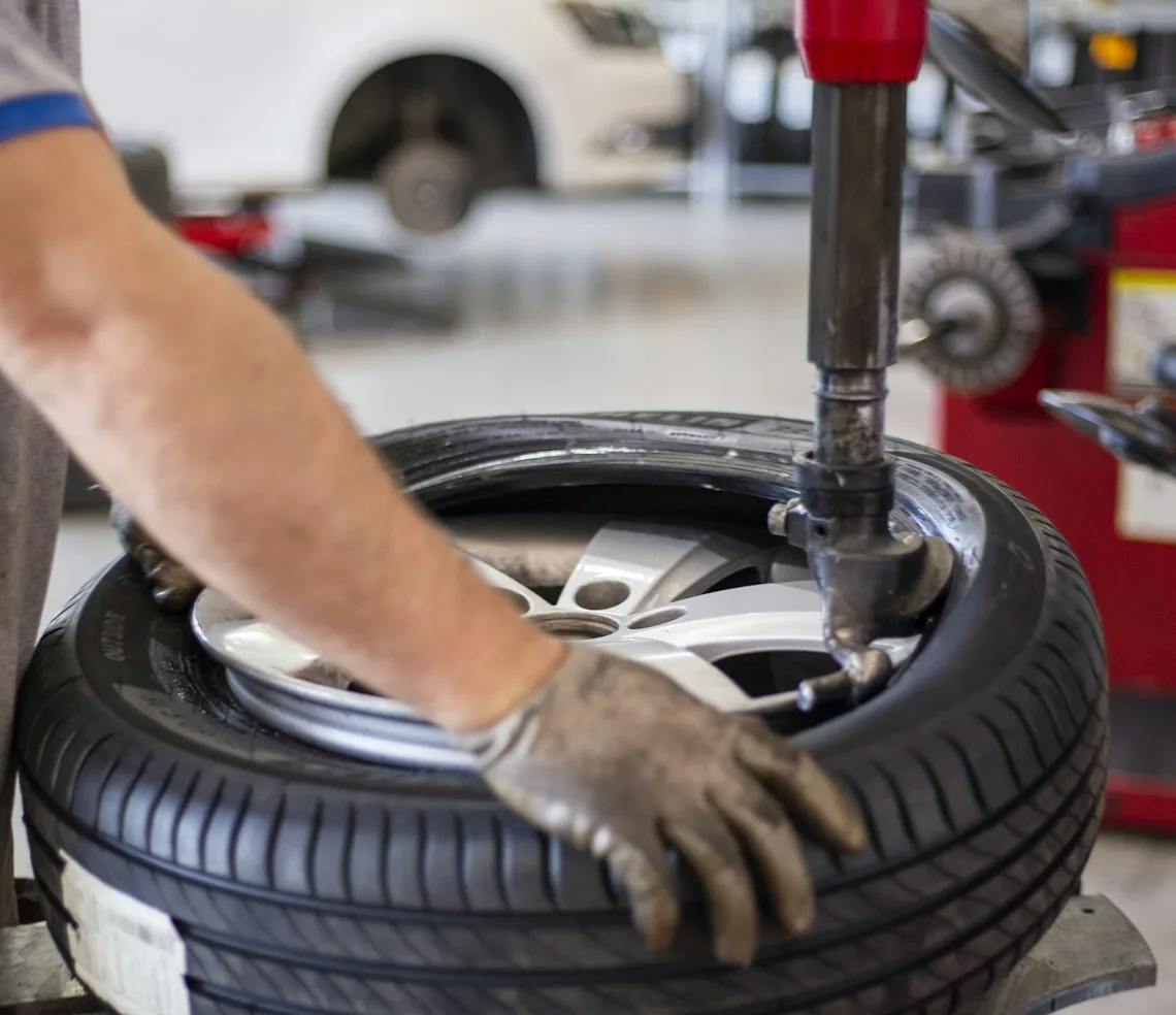 A fitter mounting a tyre on the machine