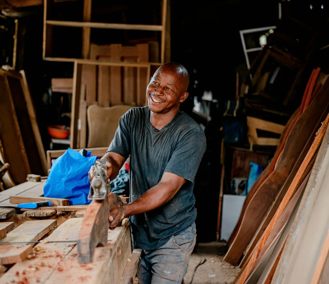 A furniture maker at work with timber in his own workshop